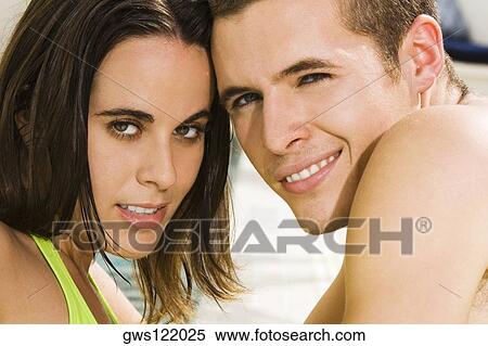 Stock Photography - Portrait of a young couple smiling. Fotosearch