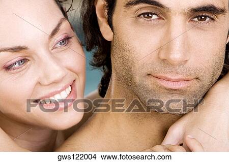 Portrait of a young woman and a mid adult man smiling View Large Photo Image Picture - Portrait of a young woman and a mid adult man smiling. Fotosearch
