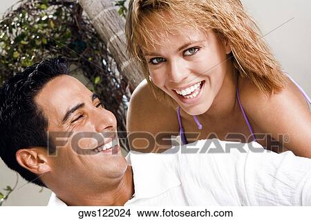 Portrait of a young woman and a mid adult man smiling View Large Photo Image Picture - Portrait of a young woman and a mid adult man smiling. Fotosearch