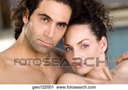 Stock Image - Portrait of a young woman and a mid adult man at the poolside. Fotosearch