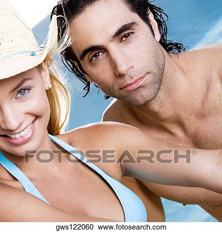 Portrait of a young woman and a mid adult man smiling View Large Photo Image Stock Image - Portrait of a young woman and a mid adult man smiling. Fotosearch