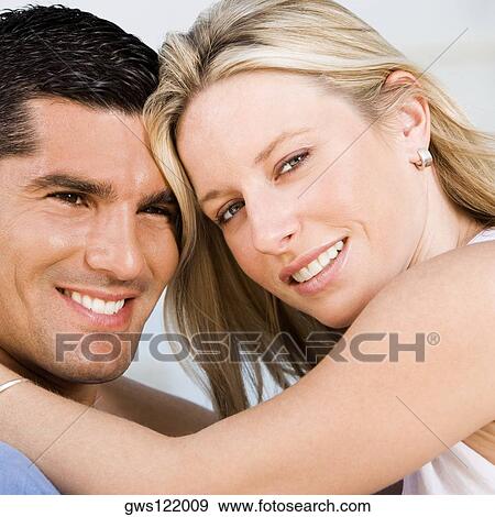 Portrait of a young woman and a mid adult man smiling View Large Photo Image Stock Photo - Portrait of a young woman and a mid adult man smiling. Fotosearch