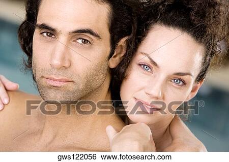 Stock Photograph - Portrait of a young woman and a mid adult man. Fotosearch