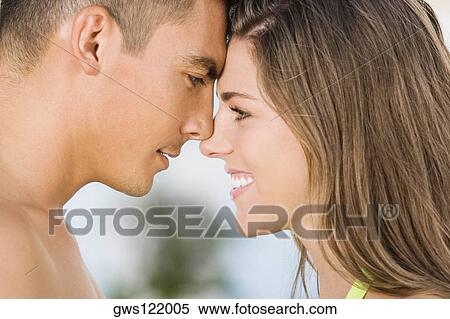 Side profile of a young couple rubbing their noses View Large Photo Image Stock Photography - Side profile of a young couple rubbing their noses. Fotosearch