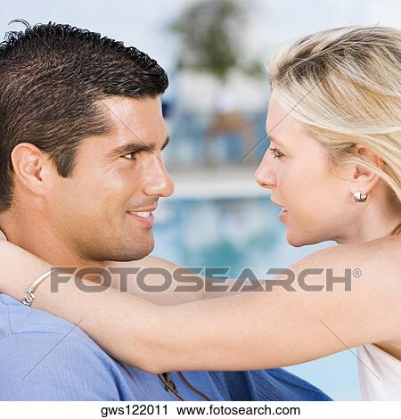 Side profile of a young woman embracing a mid adult man View Large Photo Image Stock Image - Side profile of a young woman embracing a mid adult man. Fotosearch