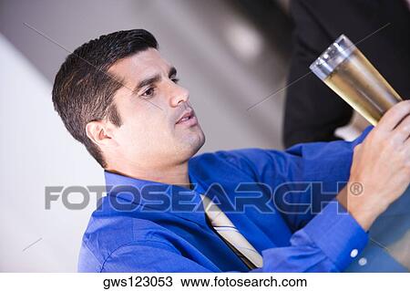 Close-up of a businessman holding a champagne flute View Large Photo Image Stock Image - Close-up of a businessman holding a champagne flute. Fotosearch