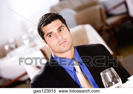 Close-up of a businessman sitting in a restaurant View Large Photo Image Stock Photography - Close-up of a businessman sitting in a restaurant. Fotosearch