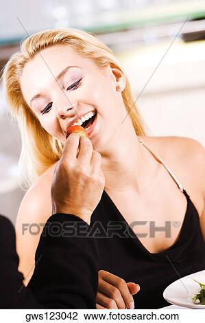 Close-up of a man feeding a strawberry to a young woman View Large Photo Image Stock Image - Close-up of a man feeding a strawberry to a young woman. Fotosearch