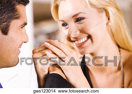 Close-up of a mid adult man and a young woman holding hands View Large Photo Image Picture - Close-up of a mid adult man and a young woman holding hands. Fotosearch