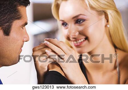 Close-up of a mid adult man and a young woman holding hands View Large Photo Image Stock Image - Close-up of a mid adult man and a young woman holding hands. Fotosearch
