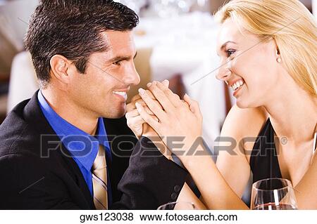 Close-up of a mid adult man and a young woman holding hands View Large Photo Image Stock Photo - Close-up of a mid adult man and a young woman holding hands. Fotosearch