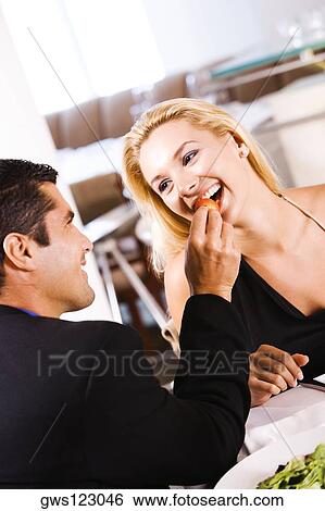 Close-up of a mid adult man feeding a young woman a strawberry View Large Photo Image Stock Photograph - Close-up of a mid adult man feeding a young woman a strawberry. Fotosearch