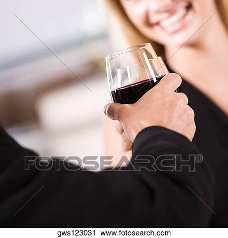 Close-up of a young couple toasting with glasses of wine View Large Photo Image Stock Image - Close-up of a young couple toasting with glasses of wine. Fotosearch