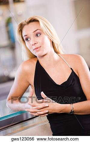 Stock Photograph - Close-up of a young woman at a bar counter. Fotosearch