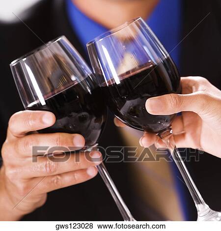 Close-up of two people toasting with wineglasses View Large Photo Image Stock Photo - Close-up of two people toasting with wineglasses. Fotosearch