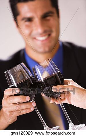 Close-up of two people toasting with wineglasses View Large Photo Image Stock Photo - Close-up of two people toasting with wineglasses. Fotosearch