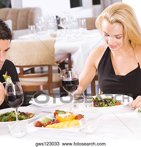 Mid adult man and a young woman sitting in a restaurant View Large Photo Image Stock Image - Mid adult man and a young woman sitting in a restaurant. Fotosearch
