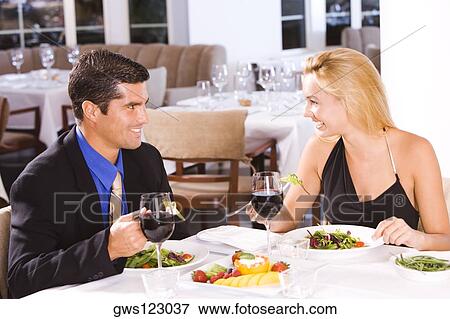 Mid adult man and a young woman sitting in a restaurant View Large Photo Image Stock Photo - Mid adult man and a young woman sitting in a restaurant. Fotosearch