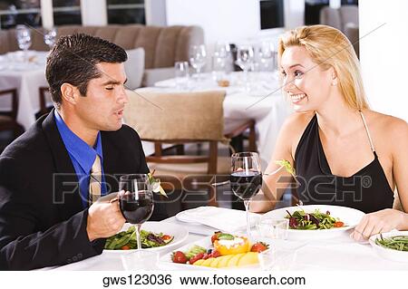 Mid adult man and a young woman sitting in a restaurant View Large Photo Image Stock Photograph - Mid adult man and a young woman sitting in a restaurant. Fotosearch