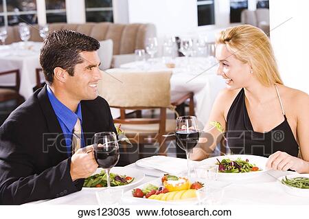 Mid adult man and a young woman sitting in a restaurant View Large Photo Image Stock Photography - Mid adult man and a young woman sitting in a restaurant. Fotosearch