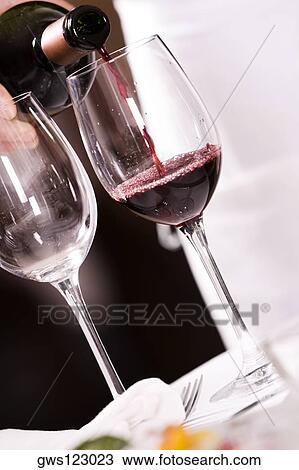 Mid section view of a man pouring red wine into a wineglass View Large Photo Image Stock Image - Mid section view of a man pouring red wine into a wineglass. Fotosearch