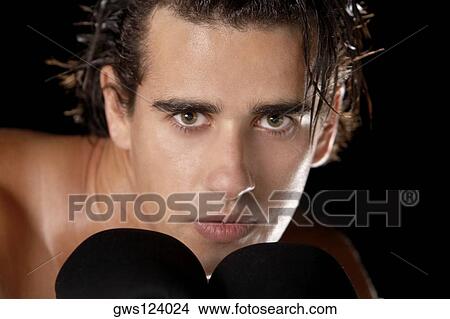 Portrait of a young man wearing boxing gloves View Large Photo Image Picture - Portrait of a young man wearing boxing gloves. Fotosearch