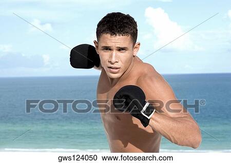 Portrait of a young man wearing boxing gloves View Large Photo Image Stock Image - Portrait of a young man wearing boxing gloves. Fotosearch