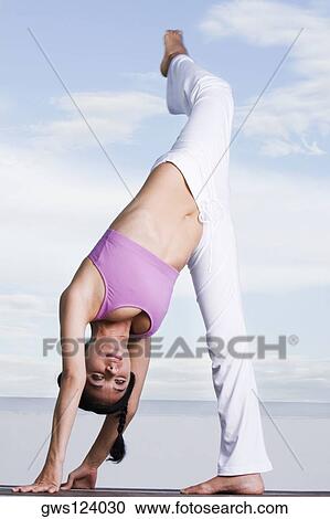 Portrait of a young woman exercising View Large Photo Image Stock Image - Portrait of a young woman exercising. Fotosearch