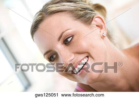 Stock Image - Close-up of a young woman smiling. Fotosearch