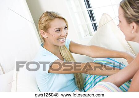 Close-up of two young women smiling View Large Photo Image Stock Photo - Close-up of two young women smiling. Fotosearch