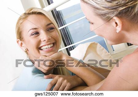 Close-up of two young women talking View Large Photo Image Stock Photo - Close-up of two young women talking. Fotosearch