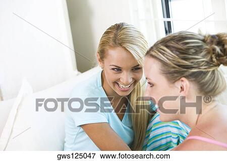Close-up of two young women talking View Large Photo Image Stock Photo - Close-up of two young women talking. Fotosearch