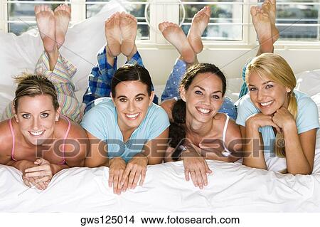 Portrait of four young women smiling View Large Photo Image Picture - Portrait of four young women smiling. Fotosearch