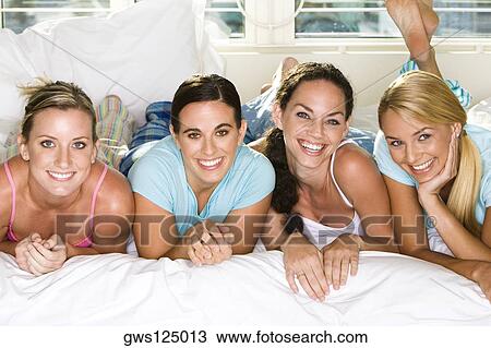 Portrait of four young women smiling View Large Photo Image Stock Image - Portrait of four young women smiling. Fotosearch