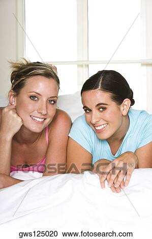 Stock Image - Portrait of two young women smiling. Fotosearch