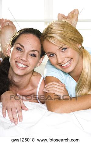 Stock Photo - Portrait of two young women smiling. Fotosearch