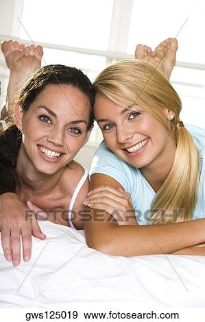 Portrait of two young women smiling View Large Photo Image Stock Photo - Portrait of two young women smiling. Fotosearch