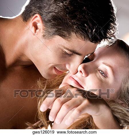 Stock Photo - Close-up of a young couple embracing each other. Fotosearch