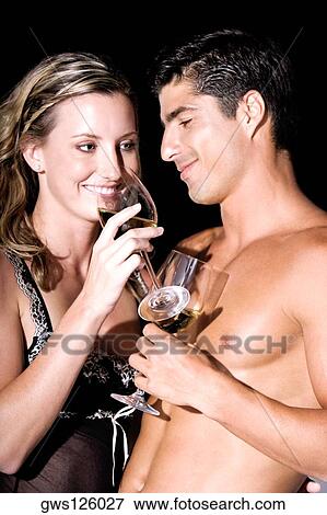 Close-up of a young couple holding wineglasses View Large Photo Image Stock Photo - Close-up of a young couple holding wineglasses. Fotosearch