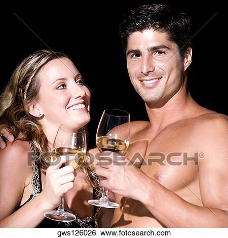 Close-up of a young couple holding wineglasses View Large Photo Image Stock Photograph - Close-up of a young couple holding wineglasses. Fotosearch