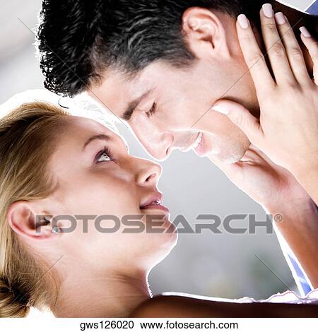 Stock Image - Close-up of a young couple kissing. Fotosearch