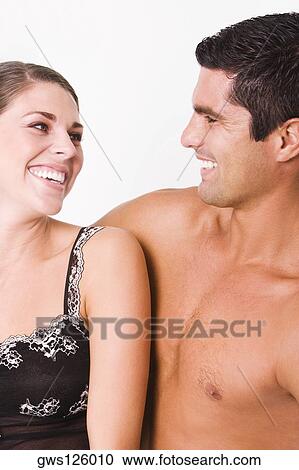 Close-up of a young woman and a mid adult man smiling View Large Photo Image Stock Image - Close-up of a young woman and a mid adult man smiling. Fotosearch