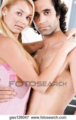Portrait of a young couple embracing each other View Large Photo Image Stock Photo - Portrait of a young couple embracing each other. Fotosearch