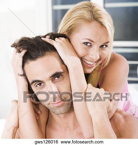 Portrait of a young couple smiling View Large Photo Image Stock Photograph - Portrait of a young couple smiling. Fotosearch