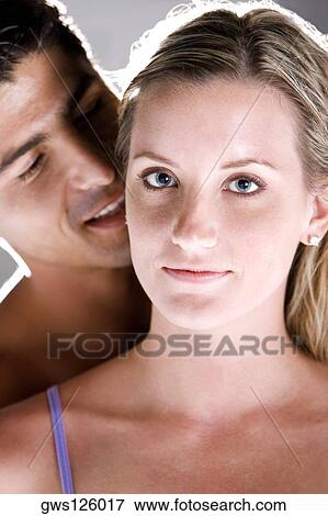 Portrait of a young woman with a mid adult man standing behind her View Large Photo Image Stock Photo - Portrait of a young woman with a mid adult man standing behind her. Fotosearch