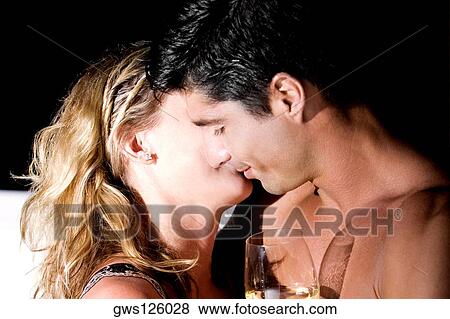 Side profile of a young couple embracing each other View Large Photo Image Stock Photo - Side profile of a young couple embracing each other. Fotosearch