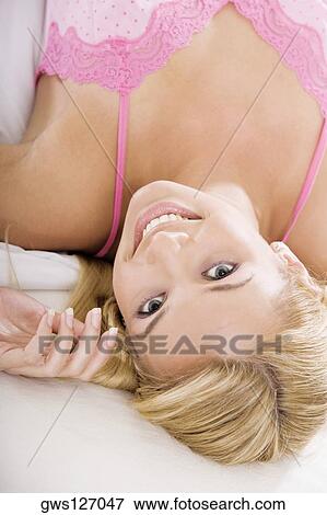 High angle view of a young woman lying on the bed View Large Photo Image Stock Photo - High angle view of a young woman lying on the bed. Fotosearch