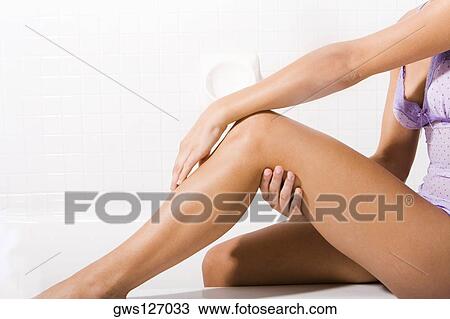 Low section view of a young woman sitting View Large Photo Image Stock Image - Low section view of a young woman sitting. Fotosearch