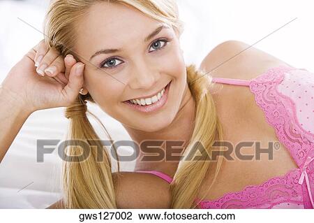 Stock Image - Portrait of a young woman smiling. Fotosearch