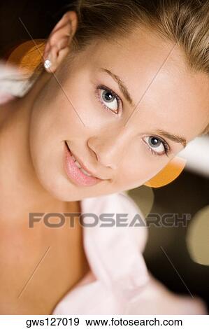 Portrait of a young woman smiling View Large Photo Image Stock Photo - Portrait of a young woman smiling. Fotosearch